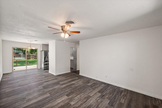 612 Elm St, Hurst, TX 76053 - unfurnished living room with dark wood-type flooring, a ceiling fan, a chandelier, and a textured ceiling