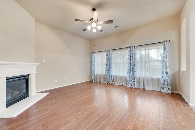 505 Glacier St, Desoto, TX 75115 - unfurnished living room featuring a ceiling fan, light wood-style flooring, and a glass covered fireplace