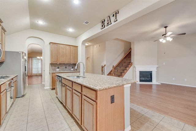 505 Glacier St, Desoto, TX 75115 - kitchen with arched walkways, light tile patterned flooring, ceiling fan, vaulted ceiling, and tasteful backsplash