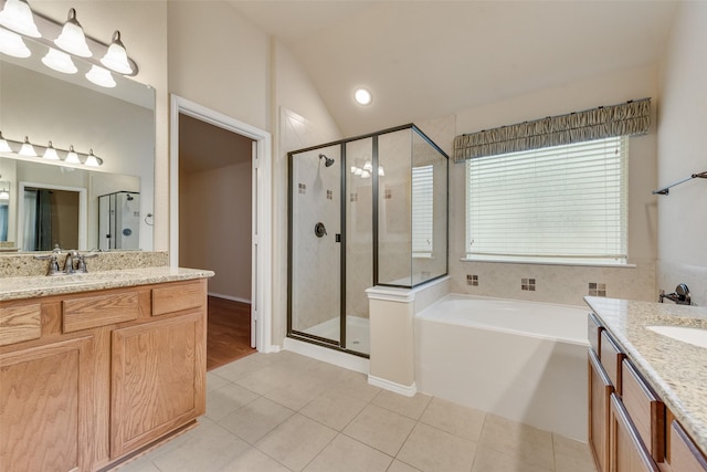 505 Glacier St, Desoto, TX 75115 - full bathroom featuring two vanities, a stall shower, a garden tub, lofted ceiling, and tile patterned flooring