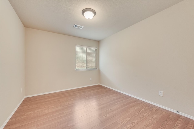 505 Glacier St, Desoto, TX 75115 - unfurnished room featuring light wood-style floors and a textured ceiling