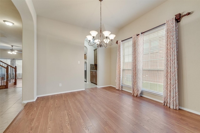 505 Glacier St, Desoto, TX 75115 - spare room featuring arched walkways, light wood-style flooring, ceiling fan, and a chandelier