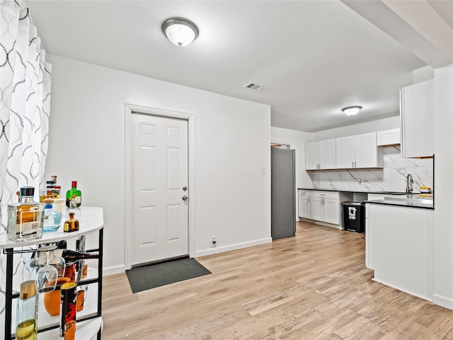4235 Bonnie View Rd, Dallas, TX 75216 - kitchen featuring freestanding refrigerator, dark countertops, and light wood-style flooring