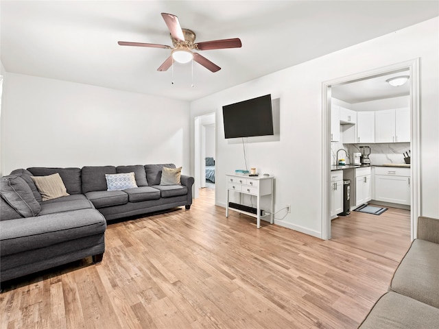 4235 Bonnie View Rd, Dallas, TX 75216 - living room featuring a ceiling fan and light wood-style flooring