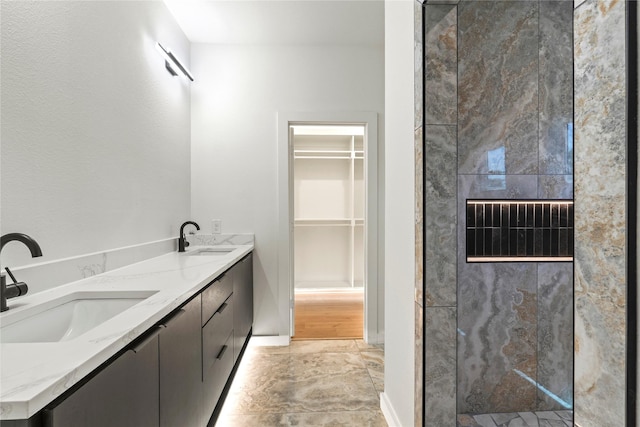 420 N Moore St, Dallas, TX 75203 - bathroom featuring tiled shower, double vanity, and a walk in closet