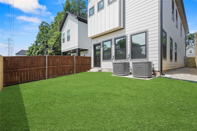 420 N Moore St, Dallas, TX 75203 - back of property featuring board and batten siding, a fenced backyard, and entry steps