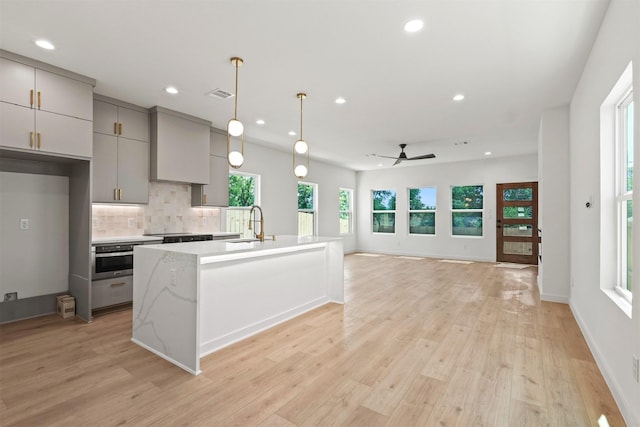 420 N Moore St, Dallas, TX 75203 - kitchen featuring gray cabinetry, a ceiling fan, recessed lighting, stainless steel oven, and tasteful backsplash
