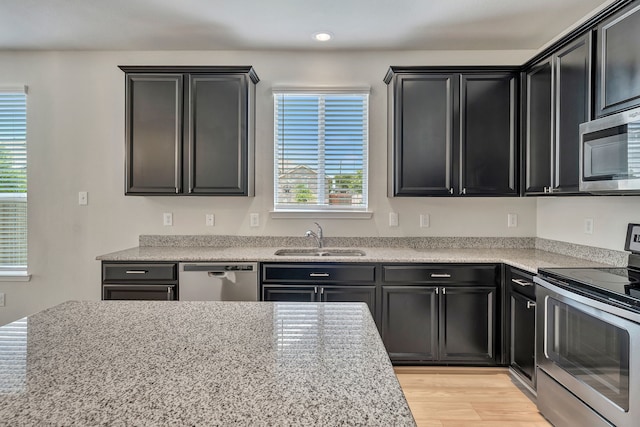 529 Mesa View Trl, Fort Worth, TX 76131 - kitchen with stainless steel appliances, dark cabinets, and light wood-style flooring