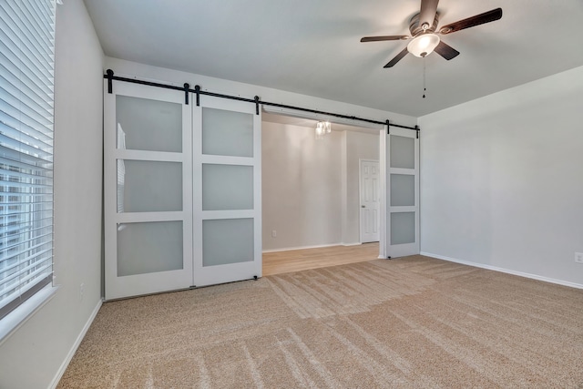 529 Mesa View Trl, Fort Worth, TX 76131 - unfurnished bedroom featuring a barn door, carpet, and ceiling fan