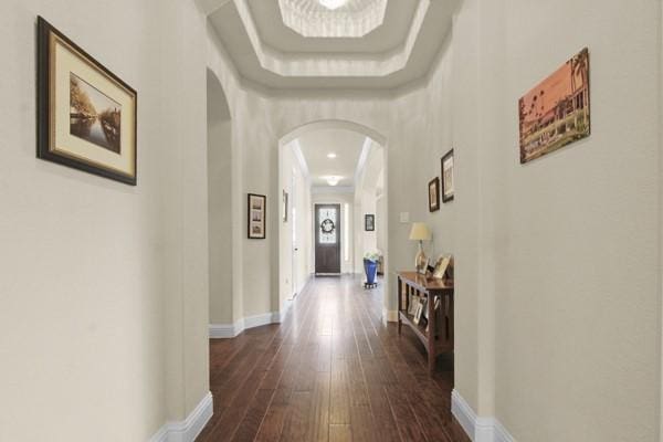 1165 Breakwater Dr, Frisco, TX 75036 - hallway featuring arched walkways and dark wood-style floors