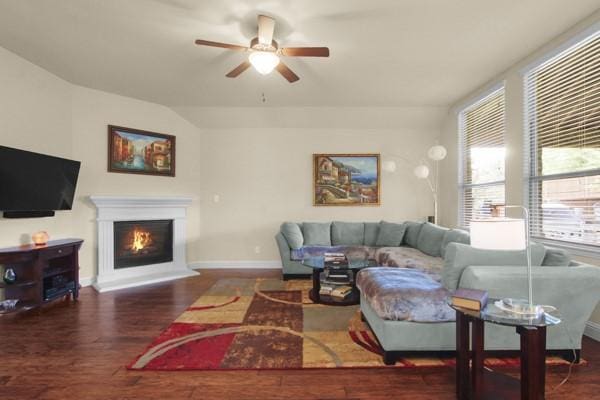 1165 Breakwater Dr, Frisco, TX 75036 - living room featuring ceiling fan, healthy amount of natural light, wood finished floors, and a lit fireplace