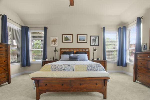 1165 Breakwater Dr, Frisco, TX 75036 - bedroom featuring light colored carpet, multiple windows, lofted ceiling, and a ceiling fan