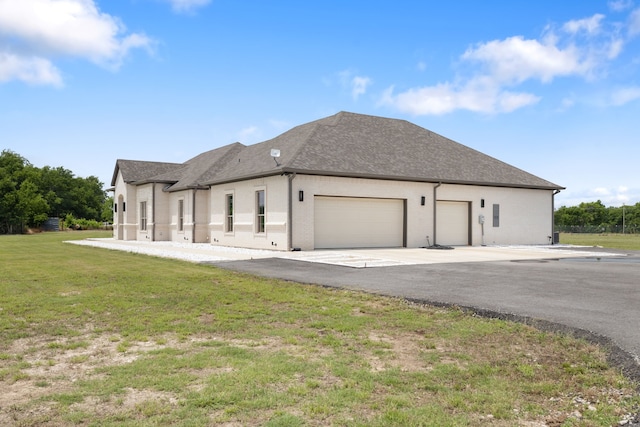 580 Vz County Road 3422, Wills Point, TX 75169 - view of side of property with an attached garage, a yard, concrete driveway, and roof with shingles