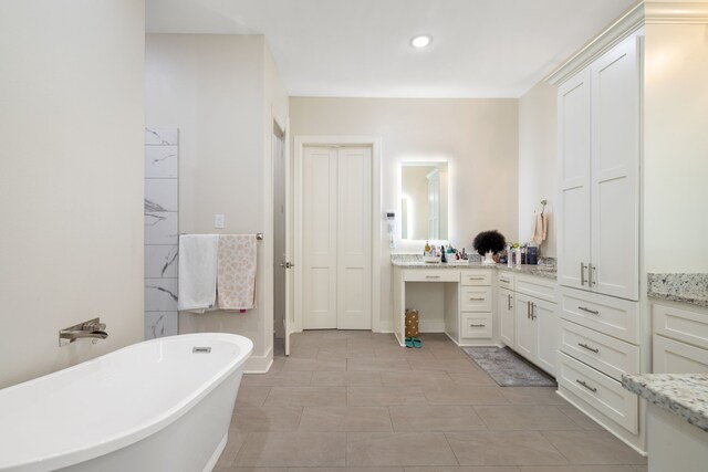580 Vz County Road 3422, Wills Point, TX 75169 - bathroom featuring a soaking tub, vanity, recessed lighting, a closet, and tile patterned flooring