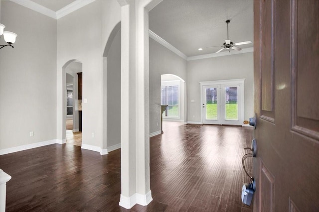7335 Kingsport Ln, Tyler, TX 75703 - entryway featuring arched walkways, a ceiling fan, dark wood-style flooring, crown molding, and a high ceiling