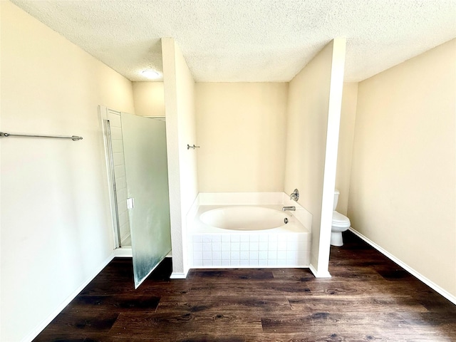 2024 Kings Forest Dr, Heartland, TX 75126 - bathroom featuring a garden tub, wood finished floors, and a textured ceiling