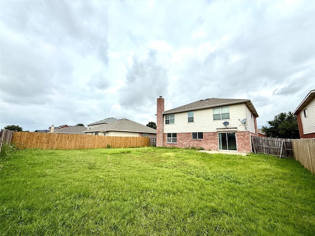 2024 Kings Forest Dr, Heartland, TX 75126 - rear view of house featuring brick siding, a chimney, and a fenced backyard