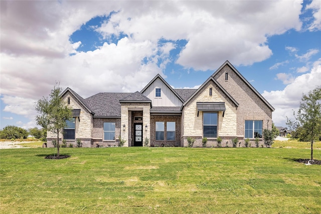 716 Burr Oak Ln, Weatherford, TX 76085 - view of front of house with board and batten siding, a front yard, brick siding, and a shingled roof