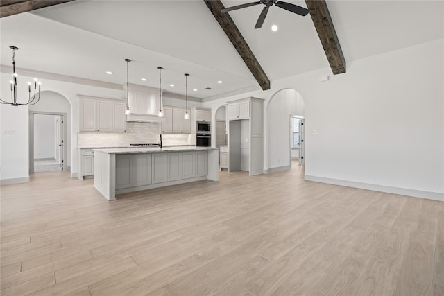 716 Burr Oak Ln, Weatherford, TX 76085 - kitchen featuring arched walkways, stainless steel microwave, ceiling fan, recessed lighting, and backsplash