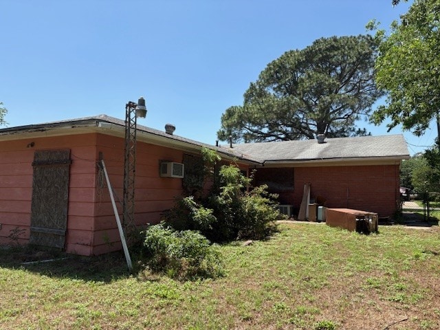 4317 Gram Ln, Waco, TX 76705 - view of property exterior featuring a lawn and a wall mounted air conditioner