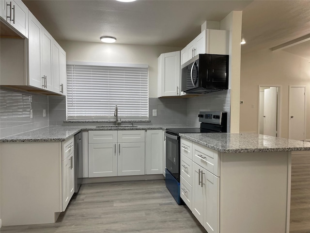 2113 Glencrest Ln, Garland, TX 75040 - kitchen featuring range with electric cooktop, light wood finished floors, light stone counters, white cabinetry, and backsplash