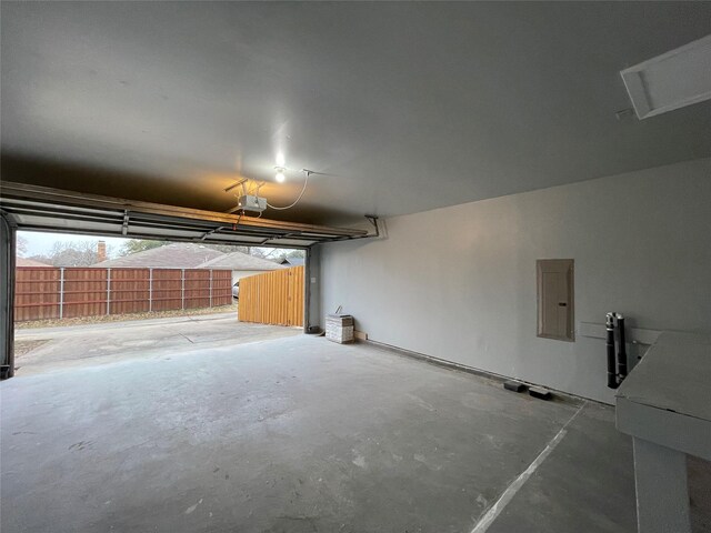 2113 Glencrest Ln, Garland, TX 75040 - garage featuring a garage door opener and electric panel