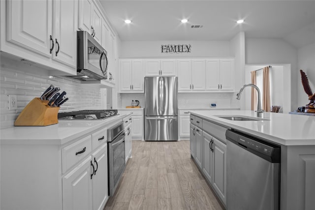 15124 Devonne Dr, Aledo, TX 76008 - kitchen with stainless steel appliances, light countertops, light wood-style flooring, white cabinetry, and recessed lighting