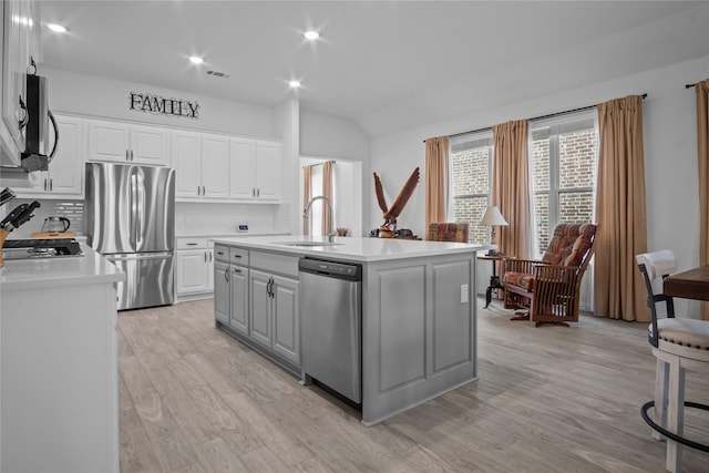 15124 Devonne Dr, Aledo, TX 76008 - kitchen featuring stainless steel appliances, light countertops, light wood-type flooring, backsplash, and vaulted ceiling