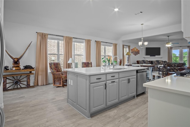 15124 Devonne Dr, Aledo, TX 76008 - kitchen with stainless steel dishwasher, a kitchen island with sink, light wood-type flooring, open floor plan, and light countertops