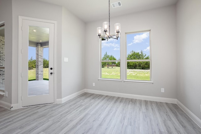 6821 Hayes Rd, Midlothian, TX 76065 - unfurnished dining area with a chandelier and light wood finished floors