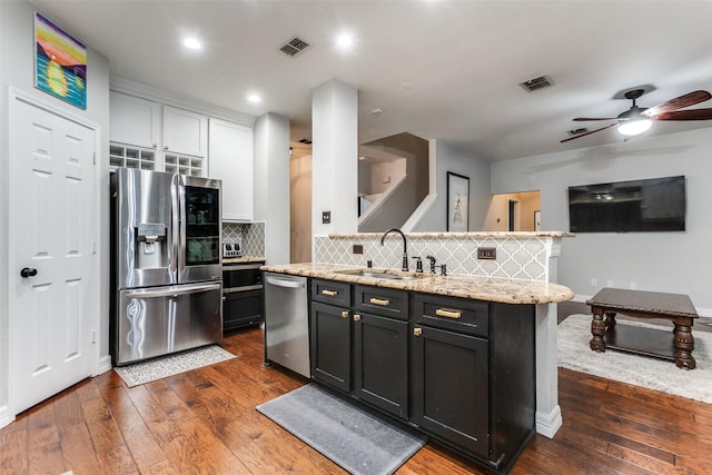 1504 Vista Bend Dr, Allen, TX 75002 - kitchen featuring stainless steel appliances, dark wood-style floors, ceiling fan, white cabinets, and recessed lighting