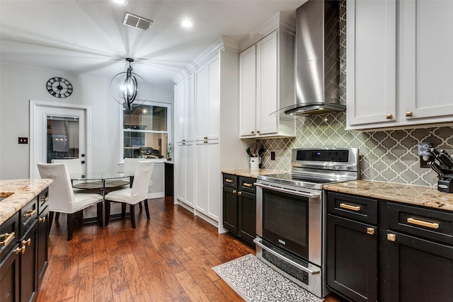 1504 Vista Bend Dr, Allen, TX 75002 - kitchen featuring stainless steel electric range, wall chimney exhaust hood, tasteful backsplash, dark cabinets, and light stone countertops