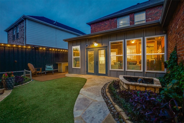 1504 Vista Bend Dr, Allen, TX 75002 - rear view of property with board and batten siding, a fire pit, and a patio