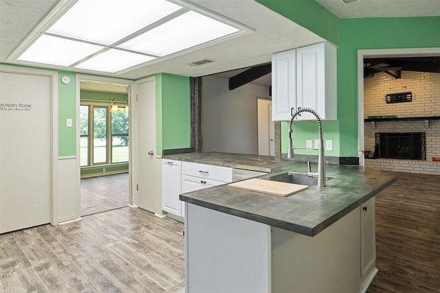 10202 Fm 1895, Kaufman, TX 75142 - kitchen with light wood-style floors, dark countertops, and white cabinetry