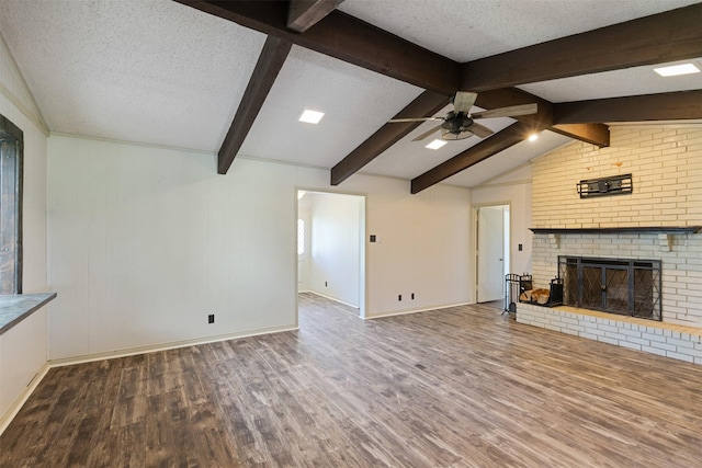 10202 Fm 1895, Kaufman, TX 75142 - unfurnished living room featuring wood finished floors, a ceiling fan, a fireplace, and a textured ceiling