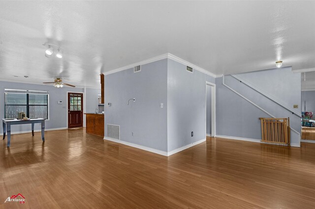 10030 Alondra St, Shreveport, LA 71115 - unfurnished living room featuring wood finished floors, a ceiling fan, ornamental molding, and stairway