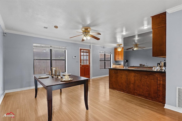 10030 Alondra St, Shreveport, LA 71115 - kitchen with light wood-type flooring, a peninsula, a ceiling fan, crown molding, and ventilation hood