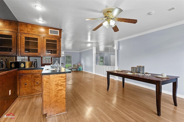 10030 Alondra St, Shreveport, LA 71115 - kitchen featuring crown molding, dark countertops, light wood-type flooring, and ceiling fan