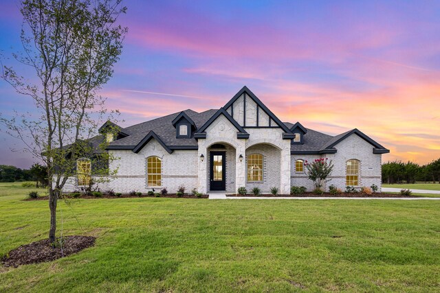7050 Champion Rd, Midlothian, TX 76065 - french country style house featuring a yard, brick siding, and a shingled roof