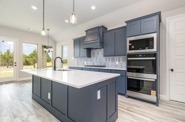 7050 Champion Rd, Midlothian, TX 76065 - kitchen with stainless steel appliances, custom exhaust hood, backsplash, light wood finished floors, and light countertops
