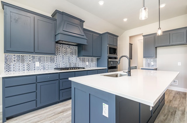 7050 Champion Rd, Midlothian, TX 76065 - kitchen featuring stainless steel appliances, light wood-style floors, a center island with sink, decorative light fixtures, and recessed lighting