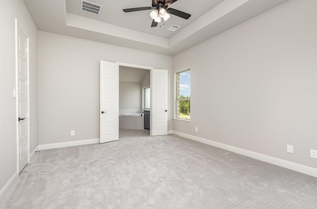 7050 Champion Rd, Midlothian, TX 76065 - unfurnished bedroom with light carpet, a raised ceiling, and a ceiling fan