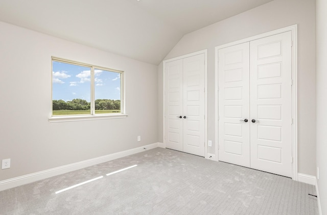7050 Champion Rd, Midlothian, TX 76065 - unfurnished bedroom with vaulted ceiling, carpet, and multiple closets