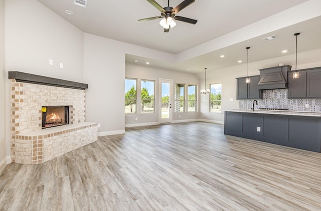 7050 Champion Rd, Midlothian, TX 76065 - unfurnished living room with ceiling fan, light wood finished floors, a fireplace, and recessed lighting