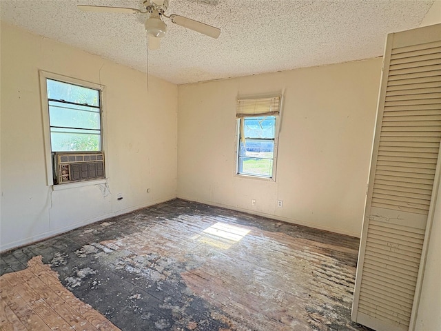 607 Baylor St, Nocona, TX 76255 - unfurnished bedroom featuring cooling unit, a textured ceiling, a closet, and ceiling fan