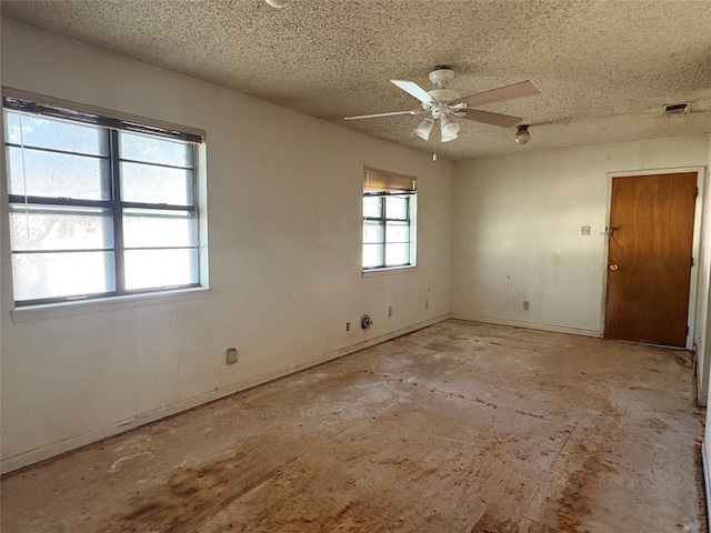 607 Baylor St, Nocona, TX 76255 - empty room featuring a textured ceiling and ceiling fan
