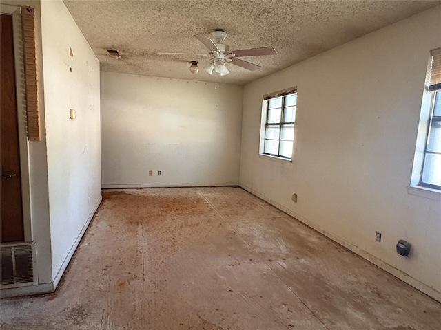 607 Baylor St, Nocona, TX 76255 - empty room featuring healthy amount of natural light, ceiling fan, and a textured ceiling
