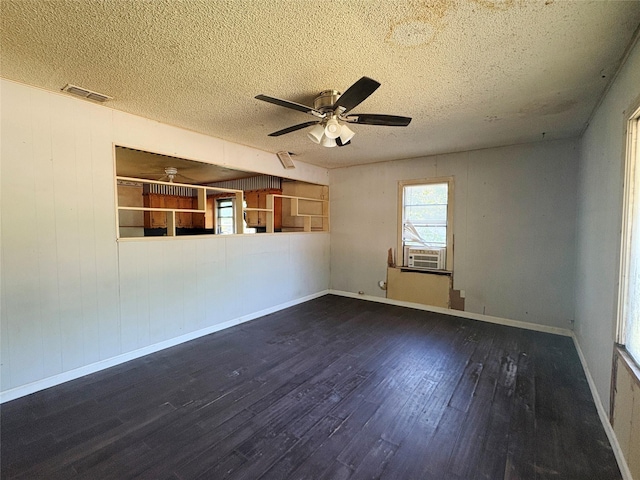 607 Baylor St, Nocona, TX 76255 - unfurnished living room featuring wood finished floors, a textured ceiling, and ceiling fan