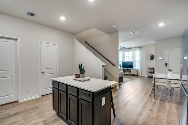 2016 Saddle Way, Mesquite, TX 75149 - kitchen with light wood-style flooring, a center island, a kitchen breakfast bar, light countertops, and ceiling fan