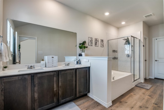 2016 Saddle Way, Mesquite, TX 75149 - bathroom featuring wood finished floors, a shower stall, a garden tub, double vanity, and recessed lighting